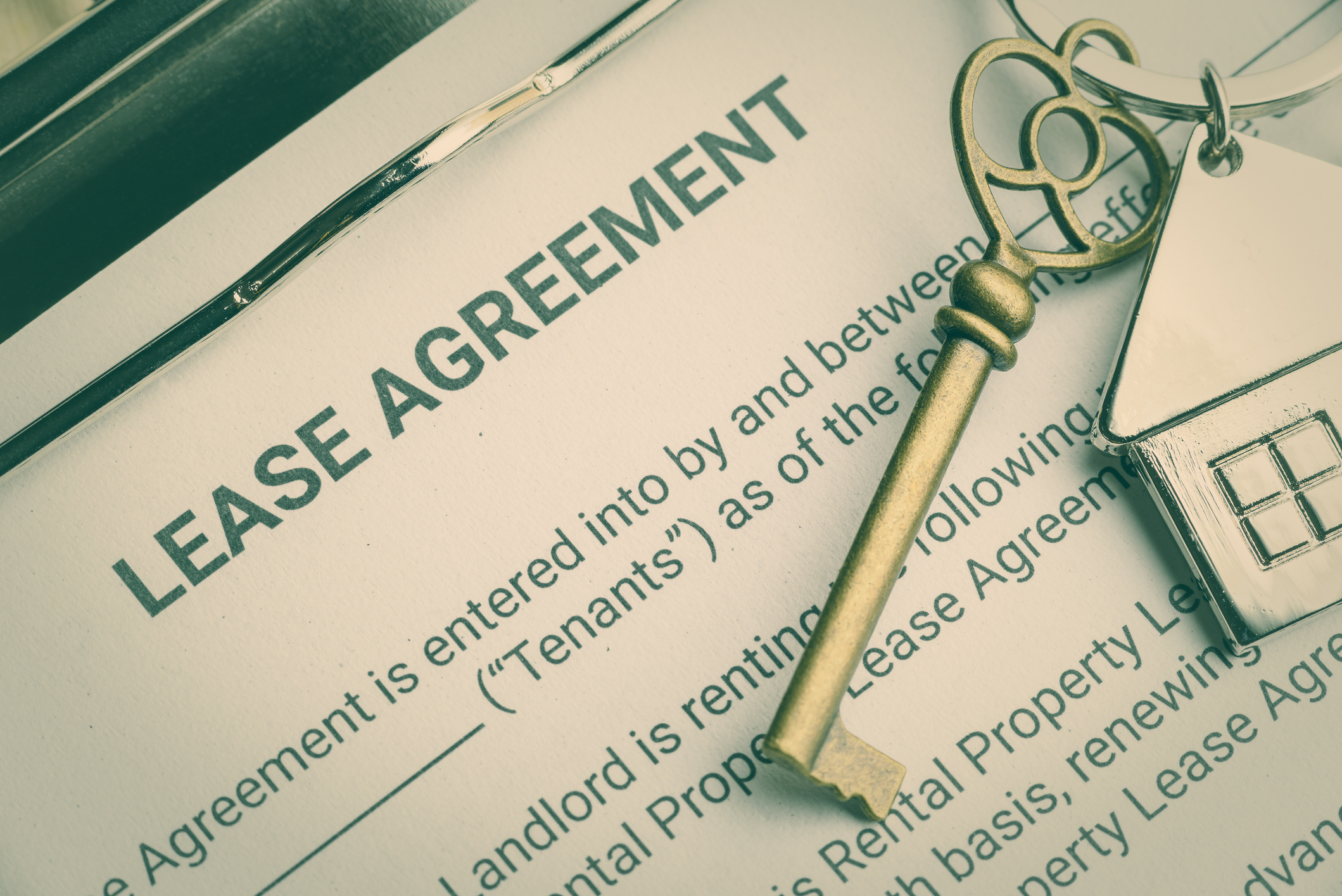 Business lease agreement concept : Keychain on a lease agreement form. Lease agreement is a contract between a lessor and a lessee that allow lessee rights to use of a property owned by lessor