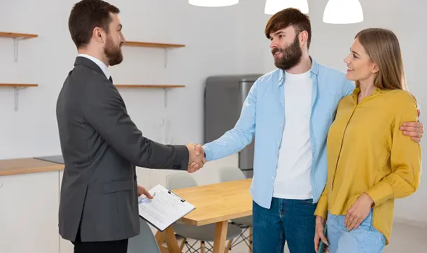 male-real-estate-agent-doing-business-showing-house-potential-buying-couple-1-1